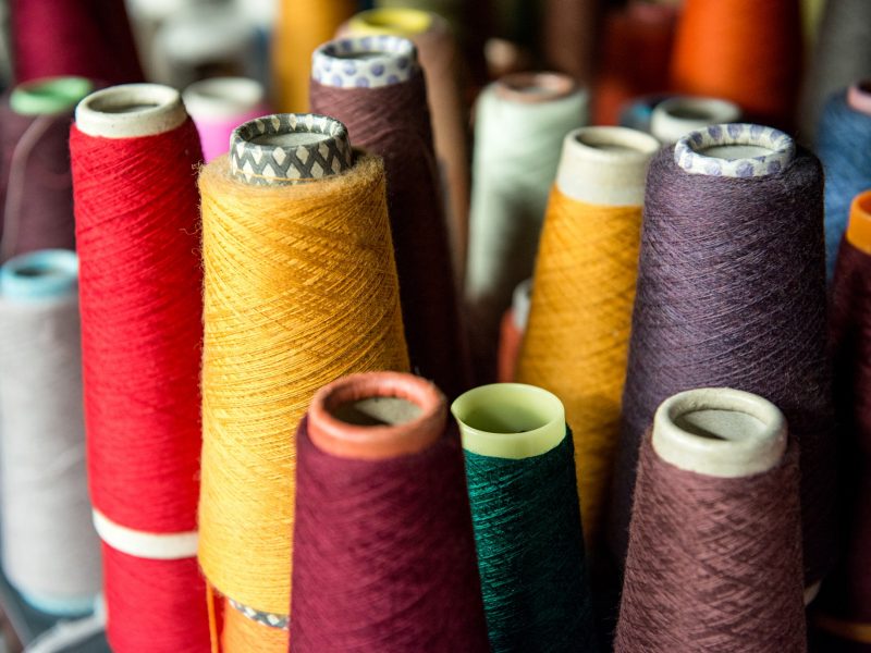 Colored cotton spools on cardboard cones