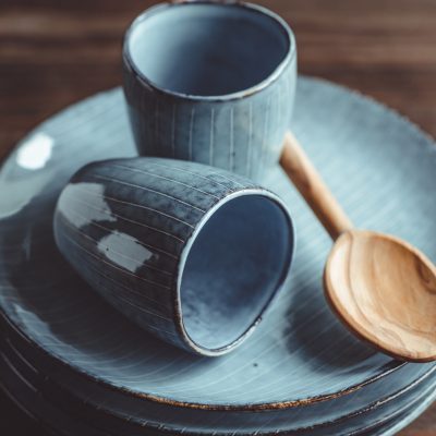 Handmade blue set of ceramic tableware. Espresso cups and plates.