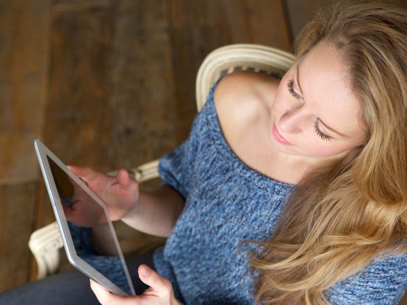 Woman learning how to use touchscreen tablet